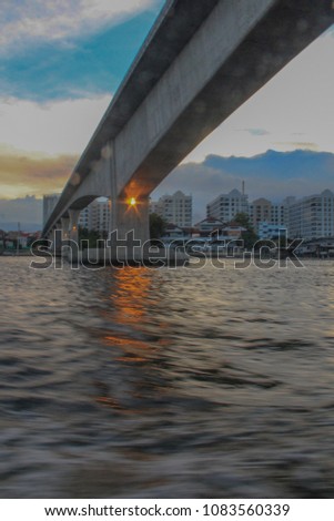 cruise river under the bridge sunset