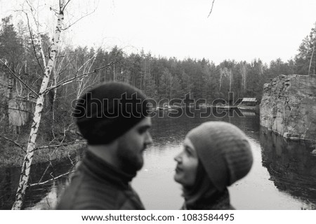 Close-up of a man and a woman at the rock. Focus on the rocks. Black and white photography.