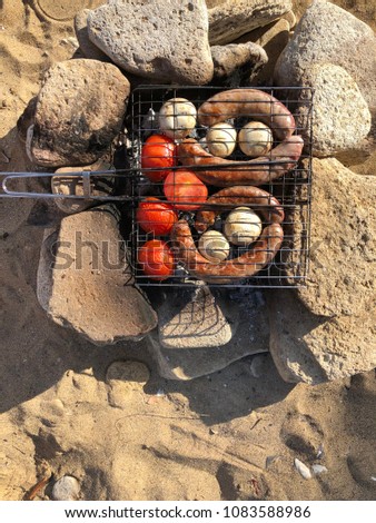 BBQ on the beach. grilled vegetables and sausages on the seashore