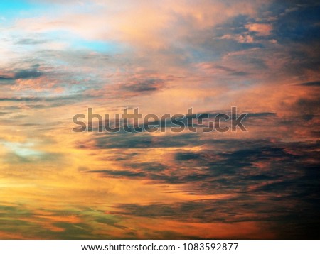 Sunset sky and clouds; mixed color abstraction red, yellow, blue, brown.