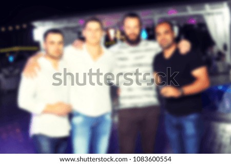 blurred for background night club party. People smiling and posing on cam during concert in night club party. Man and woman have fun at club. Boy and girl at night club party