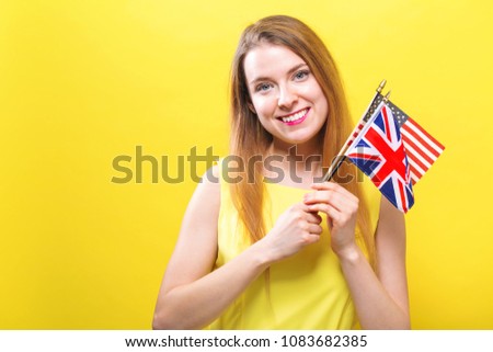 Young woman holding the flags of English speaking countries