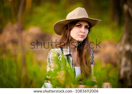 portrait of a girl in a cowboy hat at blurry background