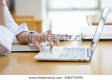 Pretty woman with headphones using a laptop