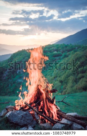 Campfire on a top of a hill with sunset