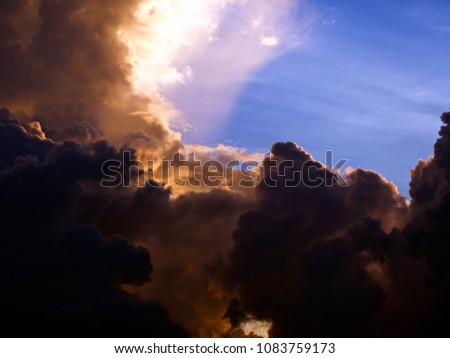 Stormy sky with big rainclouds,Colorful sunset rays.