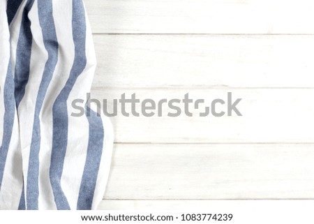 Blue tablecloth on a white wooden table surface with copy space.
