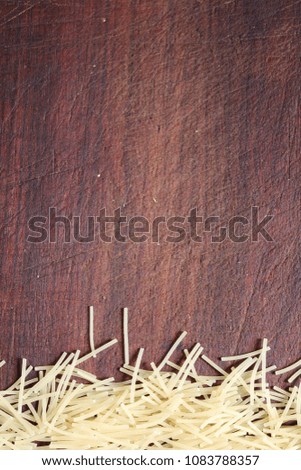 Vermicelli on an old brown wooden cutting board
