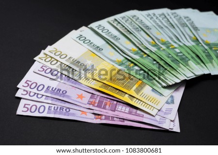 Euro banknotes on a black background
