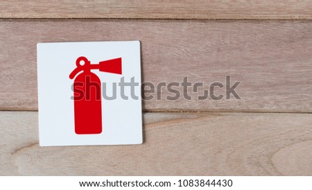fire extiguisher sign on wood wall with space for adding text on
