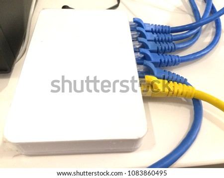 The network cable is connected to the white device network switch.