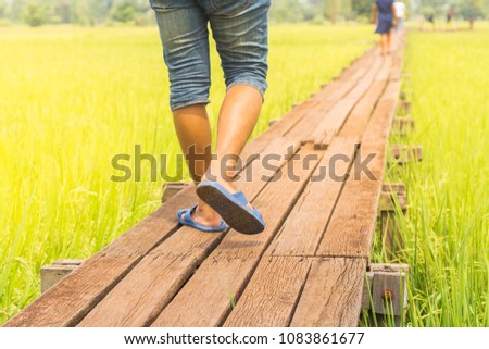 Man walking alone on lonely old wooden bridge. Like people are desperate