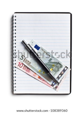 the euro currency and pen on blank notebook