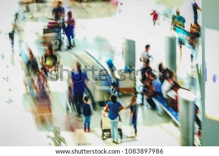 Abstract motion blurred image of people at the airport walking in line to their check in or departure gate