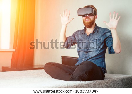 a young man in a spectacular virtual reality on the bed in the b