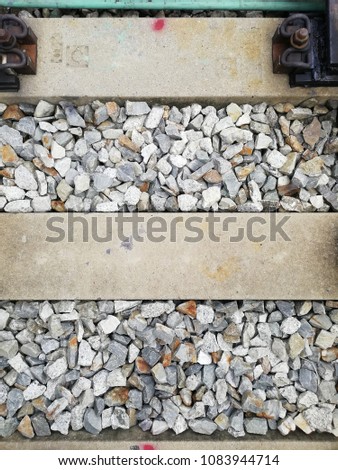railroad tracks, closed up for railroad ties or sleepers with stones background.