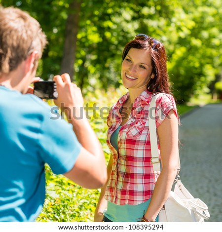 Young man take picture of his girlfriend outdoor city
