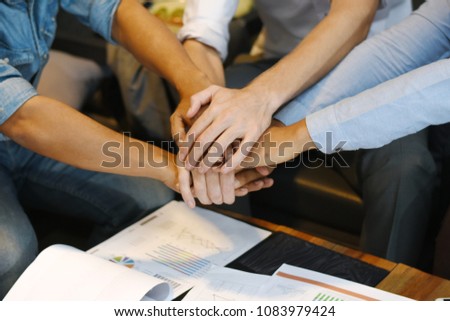 close up business people putting their hands together. stack of hands. unity and teamwork concept.