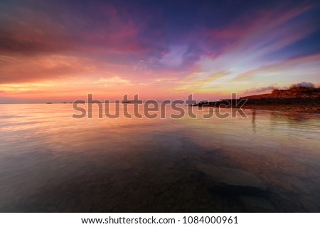 Panoramic view of sunset over ocean. Nothing but sky, clouds and water. Beautiful serene scene. soft focus due to long expose.