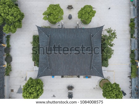 Great aerial shot of a small temple in Asia, China. Rooftop and yard overview. Background picture