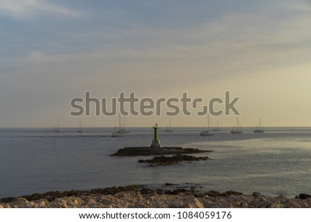 Sailing boats on Adriatic Sea in Croatia Europe. Beautiful nature and landscape photo of Dalmatian ocean at sunset on spring evening. Calm, happy and nice background photo with water, sky lighthouse.