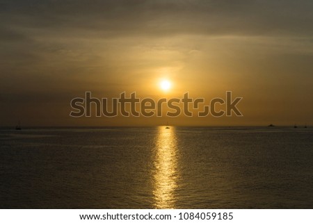Beautiful nature and landscape photo of sunset at Adriatic Sea in Dalmatia Croatia Europe. Nice colorful spring evening at the ocean. Boats at horizon. Calm, peaceful and happy background image. 