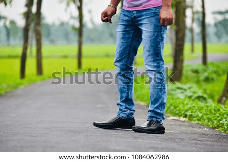 Man wearing stylish jeans and fashionable shoes isolated unique stock photograph
