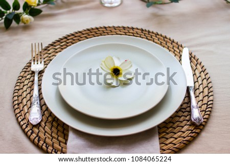 Romantic table setting for two with a flowers. Shallow depth of field.