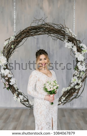 Beautiful woman in wedding dress in photo studio.