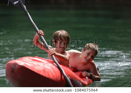 Brothers Having Fun in a Kayak 