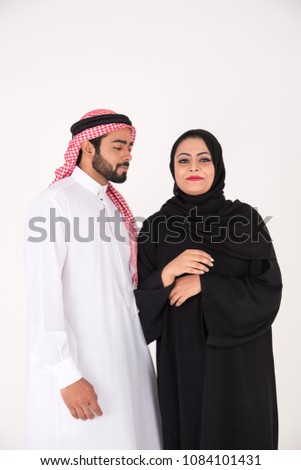 Arab muslim couple in traditional dress on white background