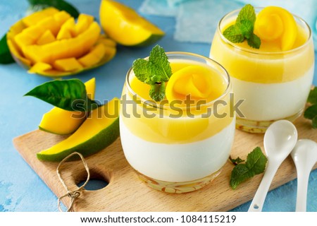 Mango Panna cotta with mango jelly and mint, Italian dessert, homemade cuisine. Royalty-Free Stock Photo #1084115219