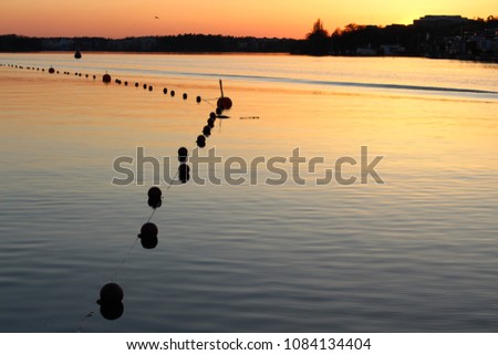 Buoys marks swimming area in fantastic sunset