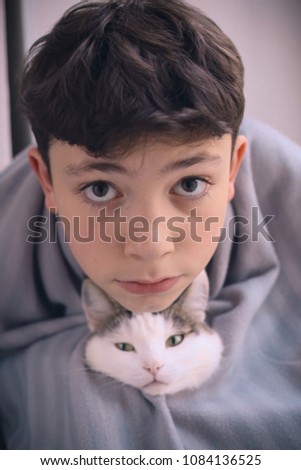 teenager kid boy and cat friends close up funny portrait photo vertical