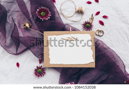 Flat lay wedding invitation card with flowers 