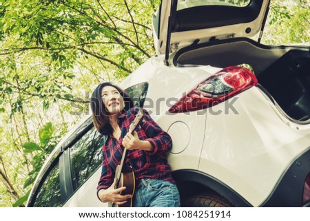 Happy beautiful and pretty Asian women solo traveler smiling, having fun and adventure journey camping in natural forest. Enjoy hipster life relax and chill during holiday in summer, autumn and spring