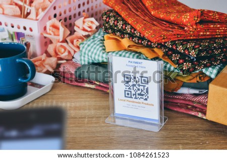 Qr code payment,  cashless technology. handmade woven accepted digital pay without money , shoping with qr code application for see fabric information,  price and payment. Royalty-Free Stock Photo #1084261523