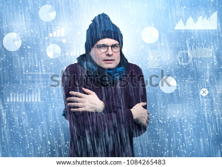 Young businessman shivering with graphs, reports and chart concept