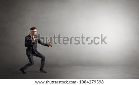 Small karate man fighting in an empty grey copy space