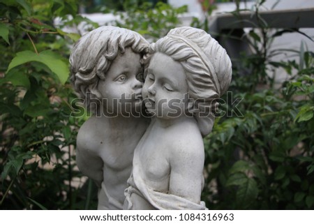 two cupids sculptures background
