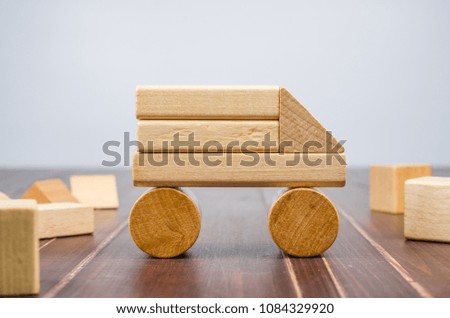 Car from wooden toy blocks on wooden board background, concept image
