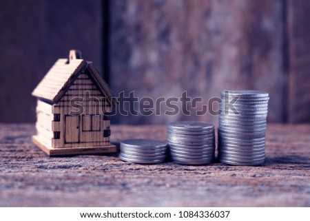 real estate investment image of  house model with stack of coins for business and growth