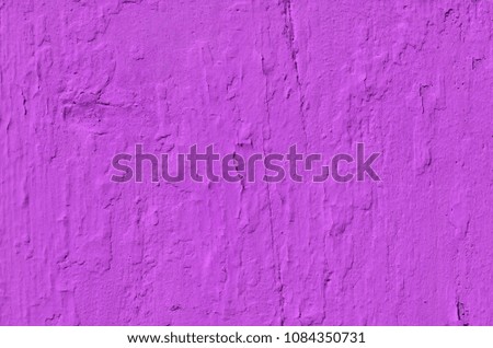 Old weathered purple paint on wooden board