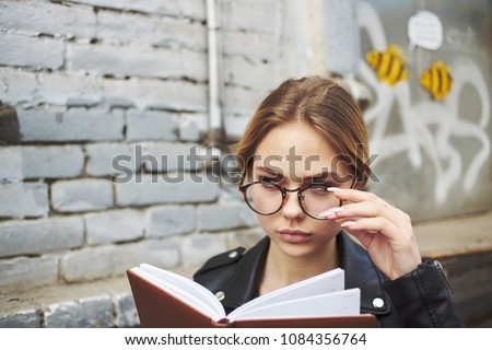  business woman with glasses with a notebook                              