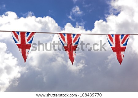 Union Jack bunting against typical English summer sky.