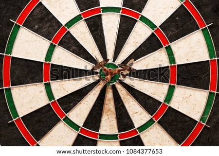 Three darts in the center of the target