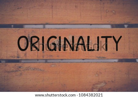 originality word written on wooden table