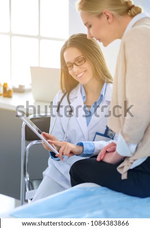 Doctor and patient discussing something while sitting at the table . Medicine and health care concept Royalty-Free Stock Photo #1084383866