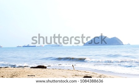 Beach view island is visible in the distance, and the cargo ship.