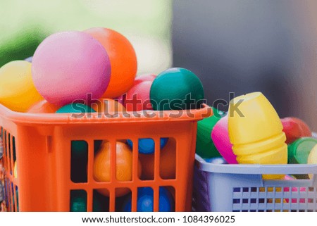 plastic toy balls and bowling pins in the basket
